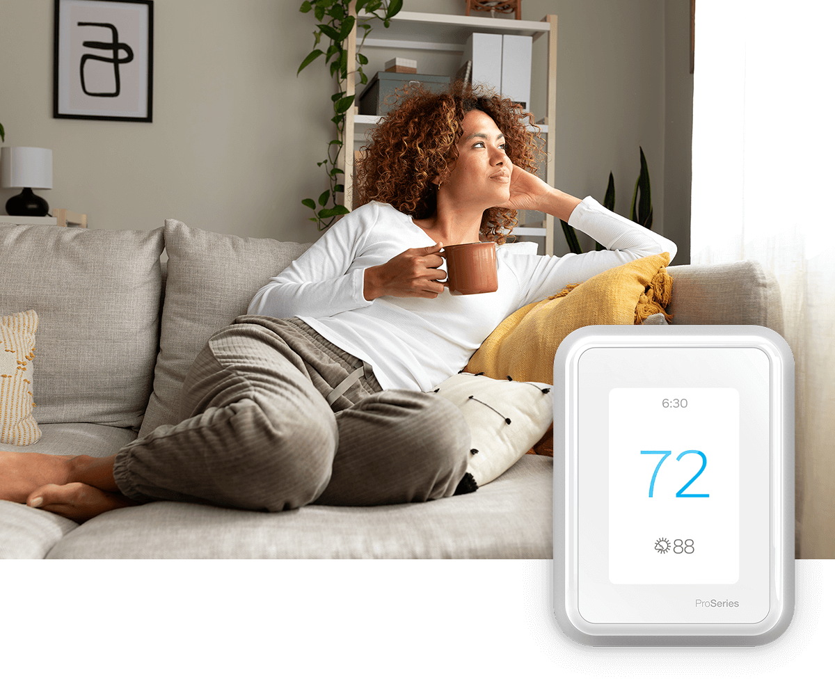 A young family shares time together in a bright room with plants and a sofa; a thermostat image is in the foreground