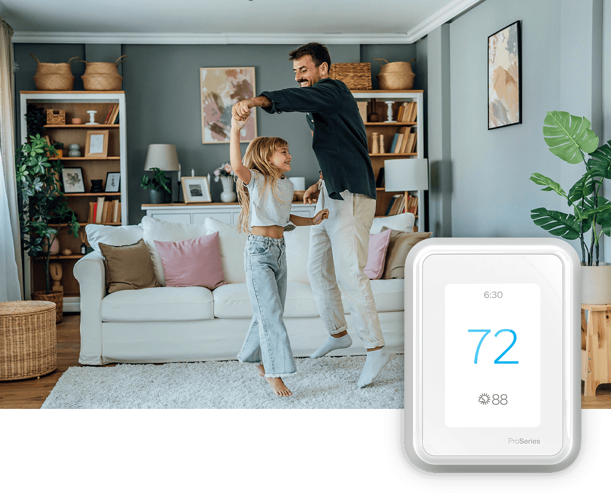 A smiling couple relaxes on the sofa, tablet in hand; a thermostat image is in the foreground