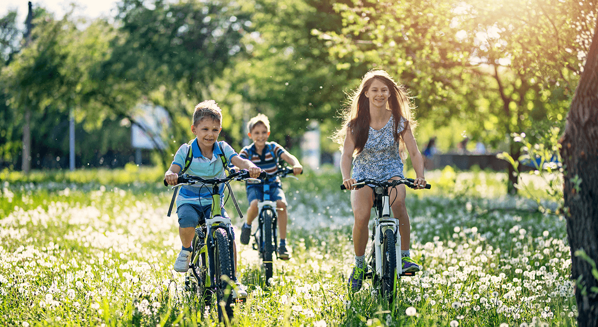 A group of children run across a field