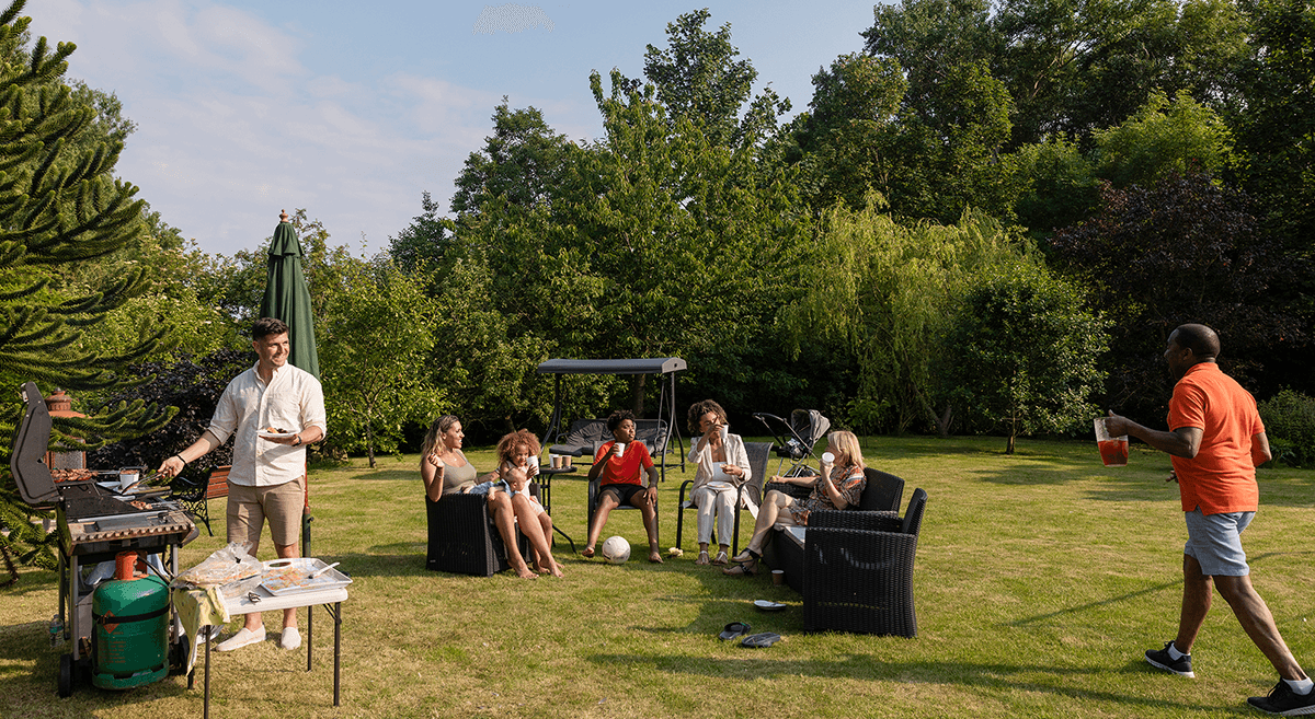 An older couple greet children running in a suburban neighborhood