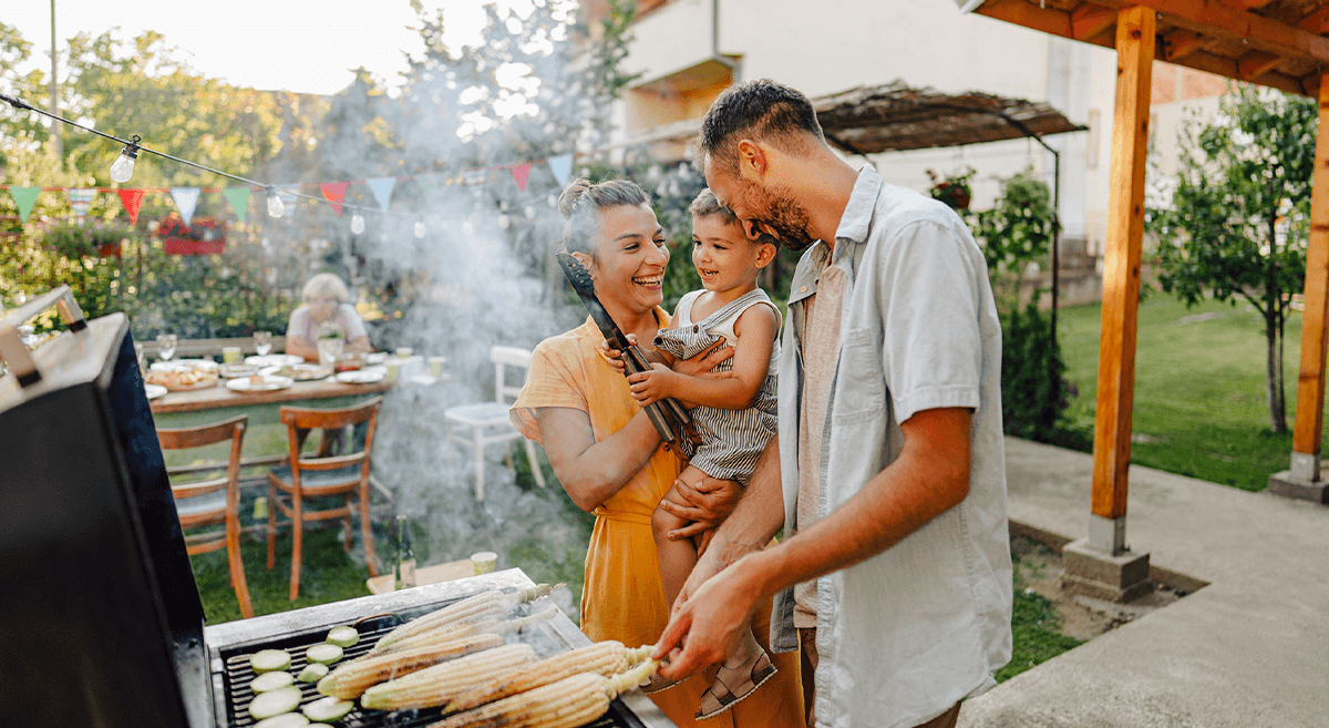 A group of children run across a field with a kite