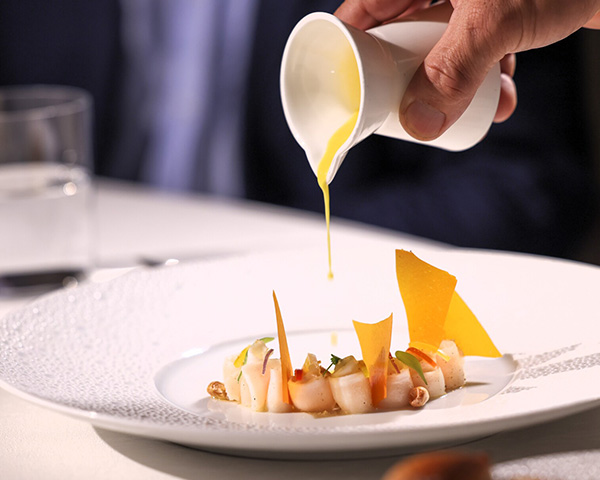 A photo of a dish being plated.