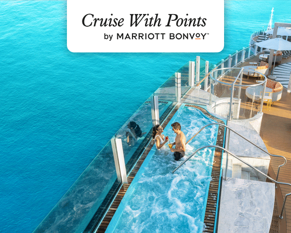 Destination image of a cruise ship floating by the coast of Santorini Greece.