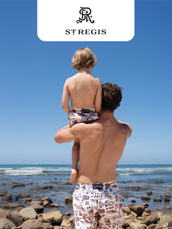 Father carrying his child on his shoulders by the ocean, with a St. Regis logo above.