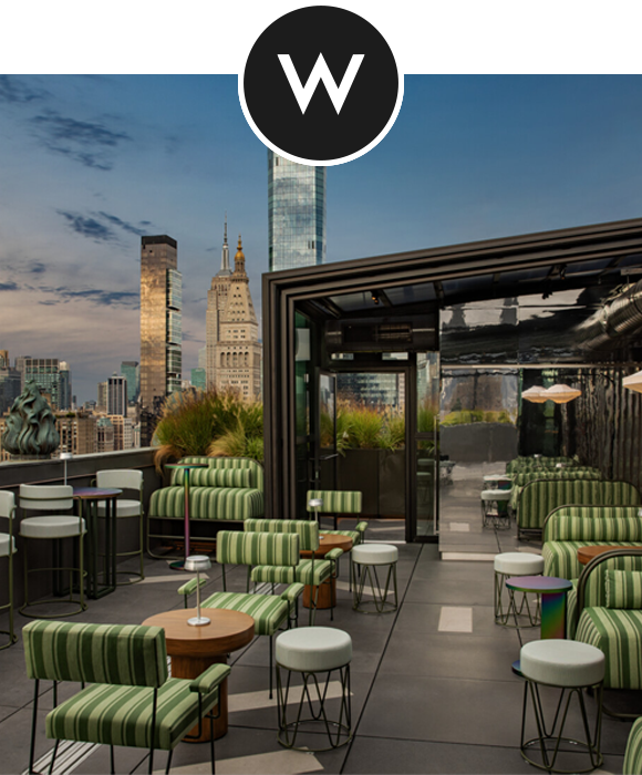 Rooftop lounge at the W New York - Union Square with green striped seating overlooking the New York City skyline.