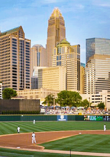 Destination image of a baseball stadium overlooking the Charlotte skyline.