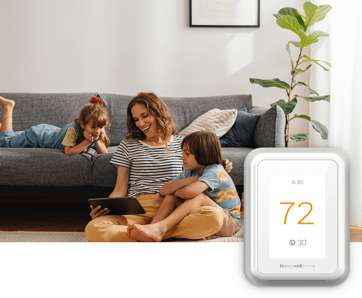 A happy mom shares her tablet screen with two young children; a thermostat image is in the foreground