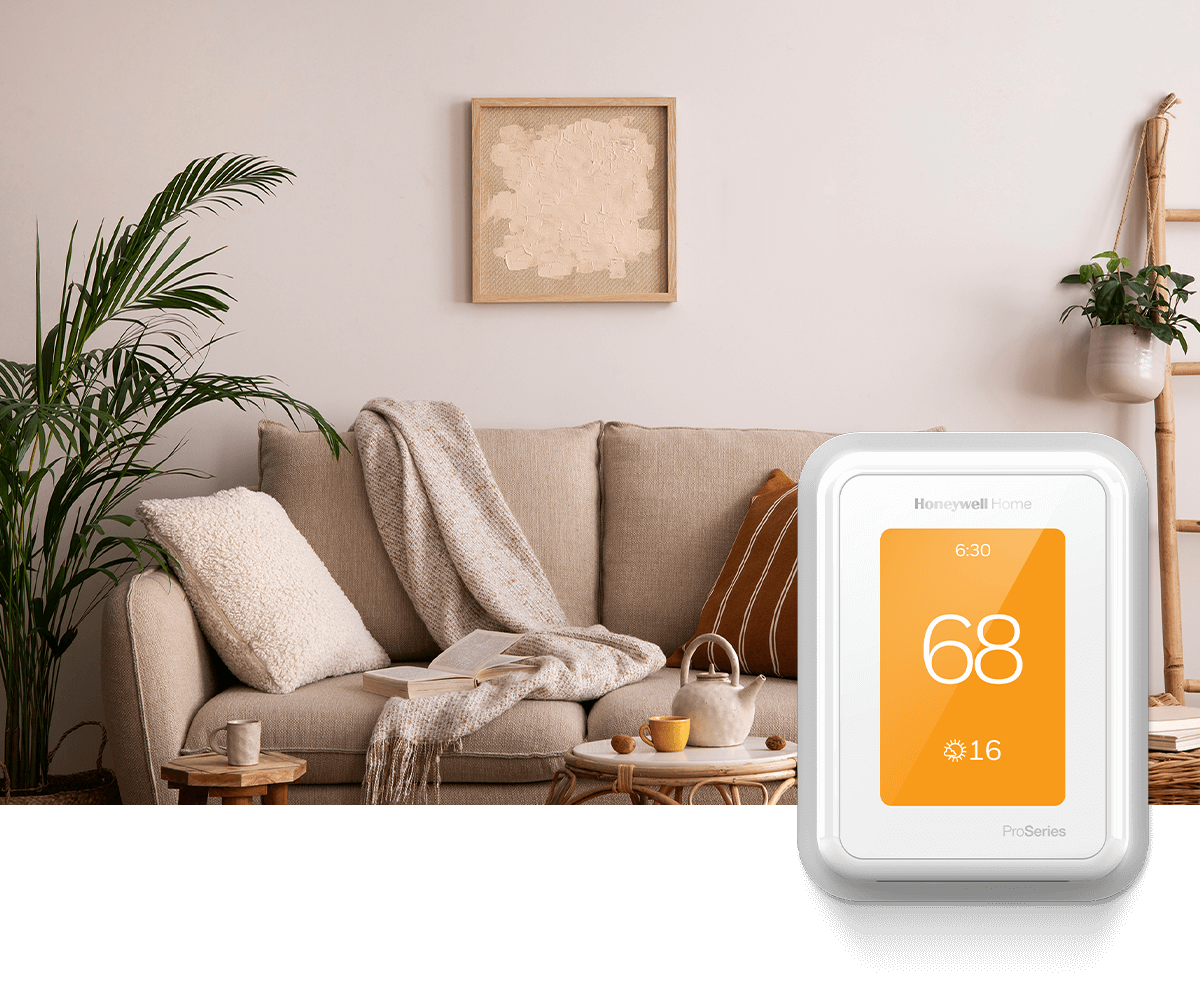 A cozy living room features a beige sofa, a small coffee table, and a Honeywell Home thermostat on the wall reading 70 degrees.