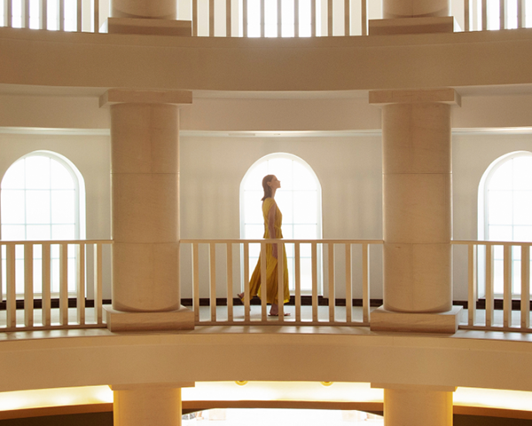 Woman walking through hallway.
