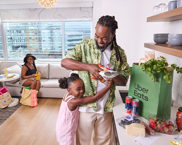 A family is unpacking their Uber Eats order.