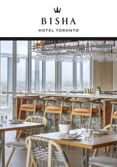 View of restaurant bar and empty tables. The skyline of the city can be seen from the large amount of windows in the background.
