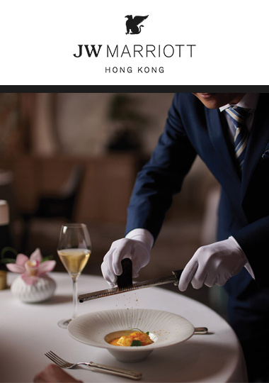 A waiter grating truffle on top of dish in an upscale resturaunt at the JW Marriott Hong Kong.