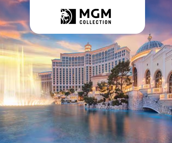 Exterior view of the Bellagio, a Luxury Collection Resort & Casino. The hotel is surrounded by water with an illuminated fountain.