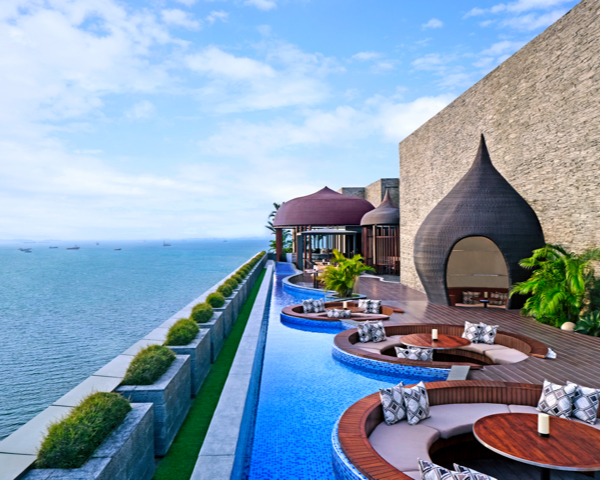 Modern balcony with infinity pool and unique architectural elements.