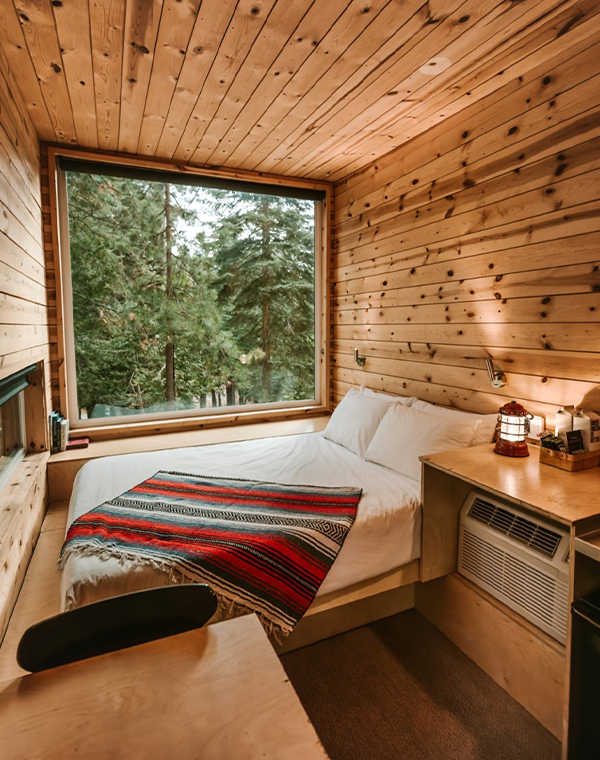 Photo of a bedroom in a log cabin style lodging.
