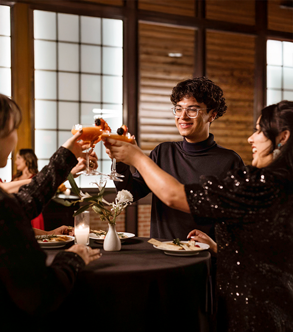A group of people enjoying an event being hosted in a hotel event space.