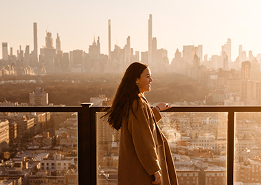 Woman looking at the skyline of New York City.