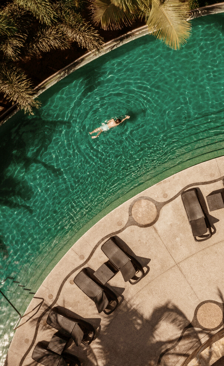 Aerial view of a person swimming in a pool.