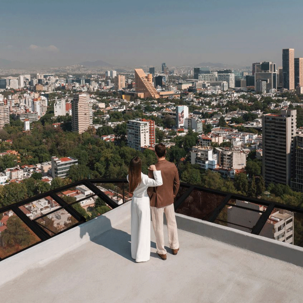 a man and woman sunbathing on lounge chairs at the JW Marriott Hotel Mexico City Polanco.