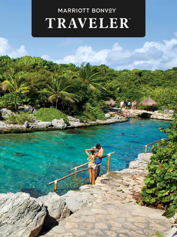 A couple stands near a wimming hole on an island.