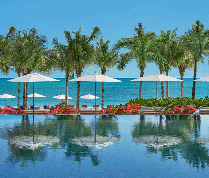 Infinity pool facing the ocean on a sunny day.