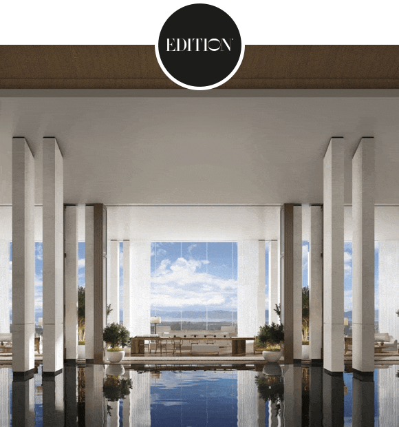 Animated GIF: Modern living room with tall fireplace and floor-to-ceiling windows followed by a modern indoor pool framed by tall columns, greenery, and distant landscape view.